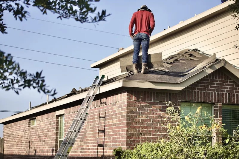 Professional roofer working on a residential roof in Boyce